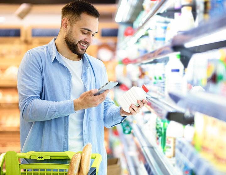 Man scanning code on products using smartphone